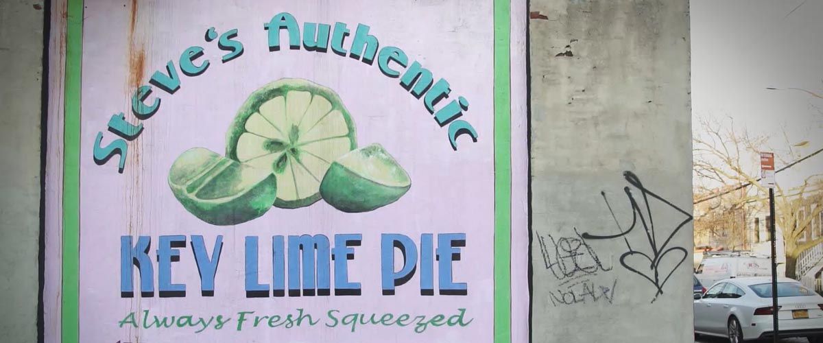 a worn Steve's Keylime Pies sign painted on the side of a building