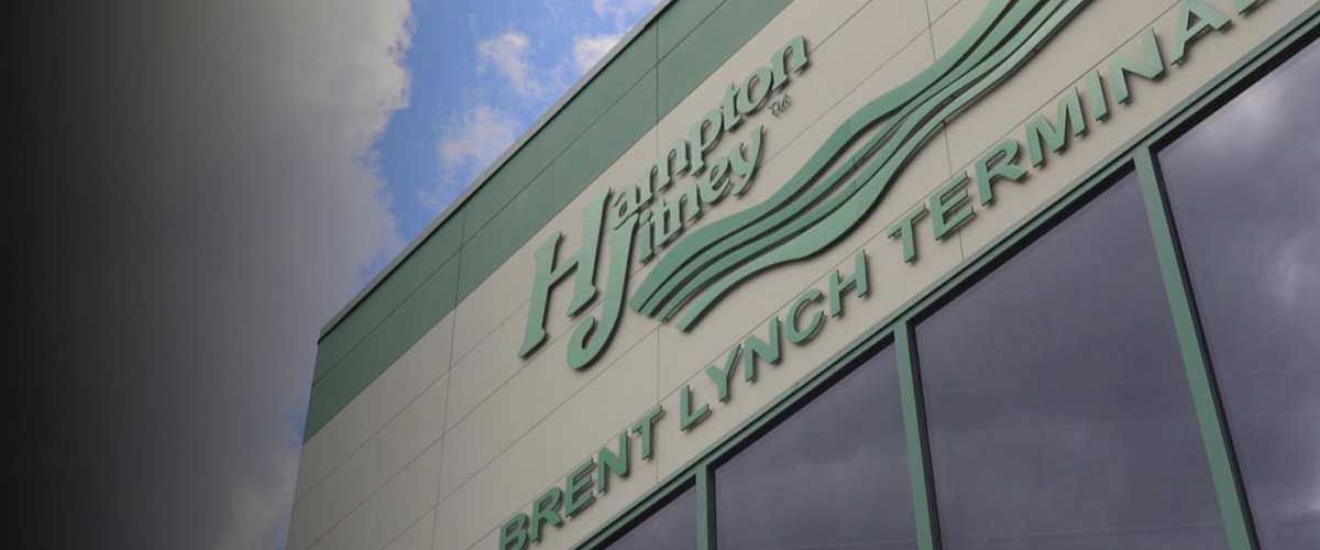 the side of a building with a sign that says Hampton Jitney