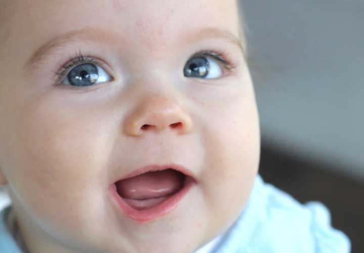 a baby with blue eyes looking up