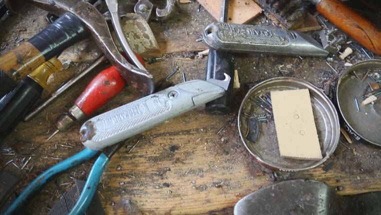 some cobblers tool on a workbench